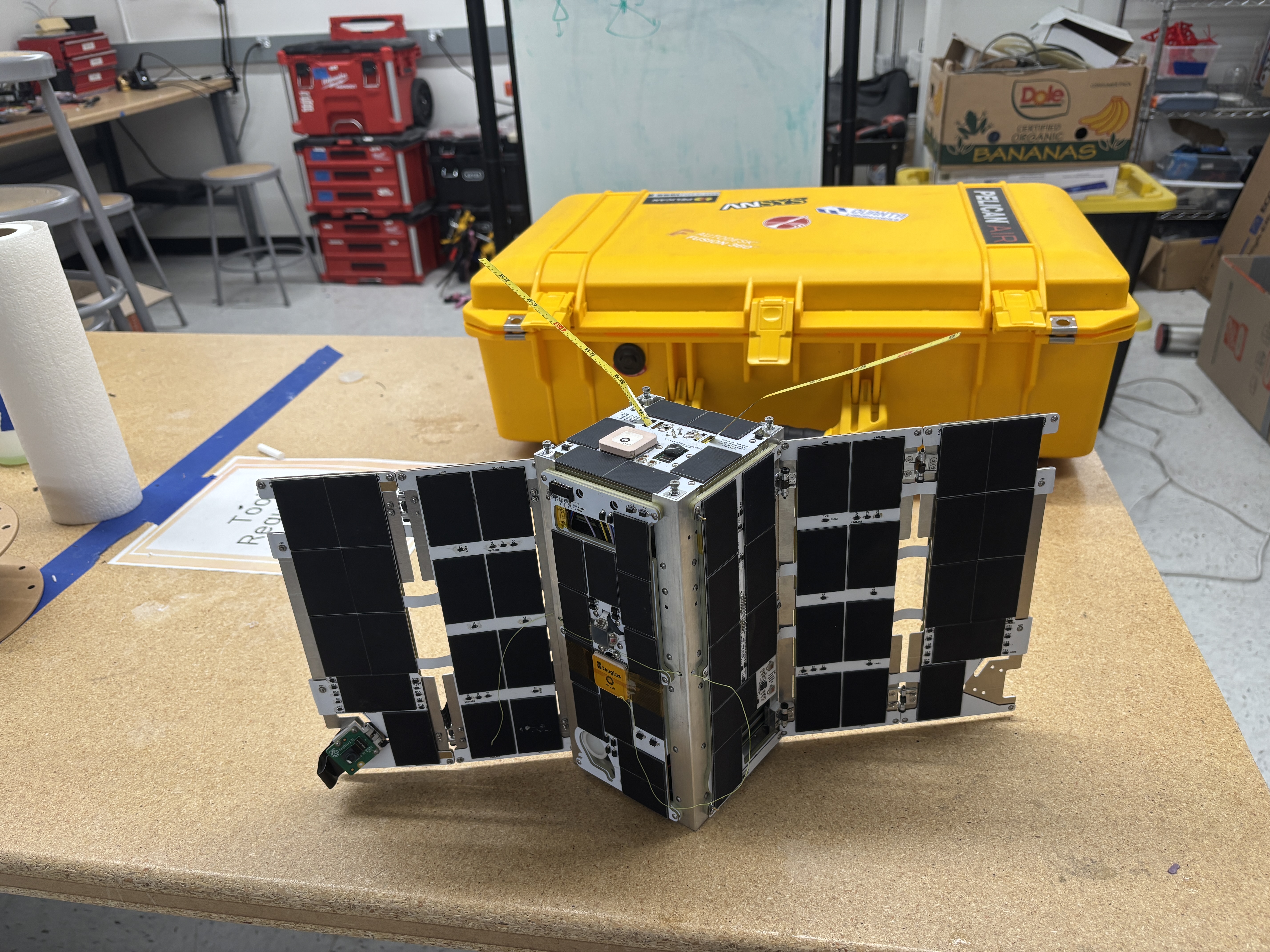 Satellite structure and hardware on a work surface